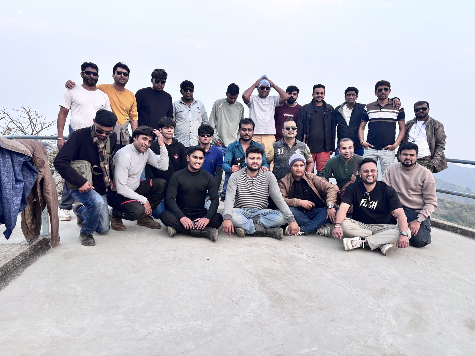 Sandeep Jain with a large group of friends at a hilltop viewpoint